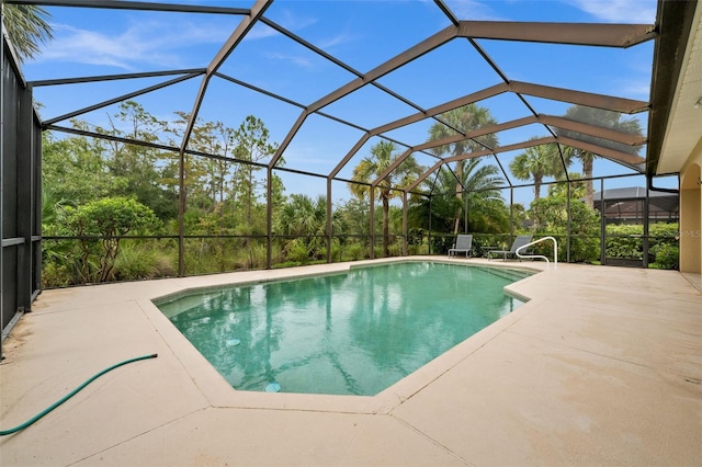 view of swimming pool with a patio and a lanai