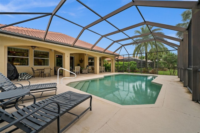 view of pool with a patio area, a lanai, and ceiling fan