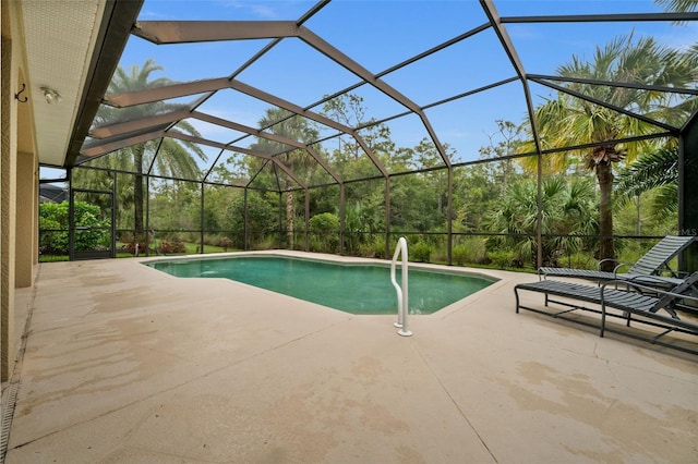 view of pool with a patio and a lanai