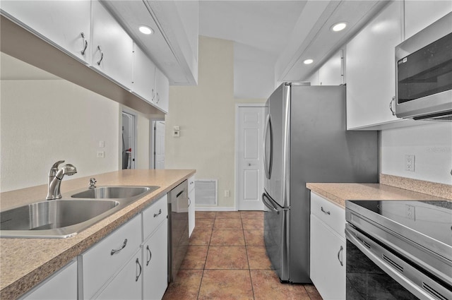 kitchen featuring light countertops, visible vents, appliances with stainless steel finishes, white cabinets, and a sink