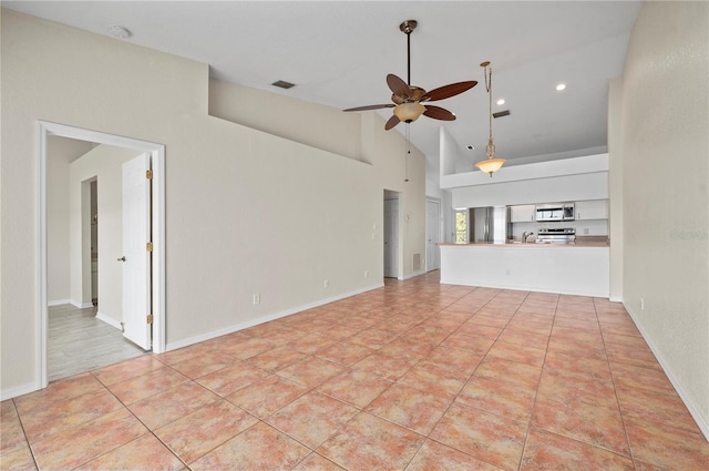 unfurnished living room featuring ceiling fan, light tile patterned flooring, sink, and high vaulted ceiling