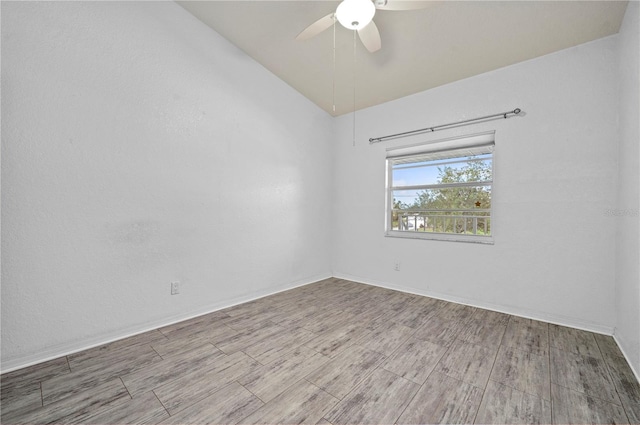 empty room featuring ceiling fan and vaulted ceiling