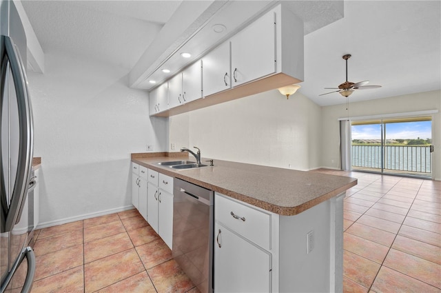 kitchen with ceiling fan, sink, stainless steel appliances, and white cabinetry