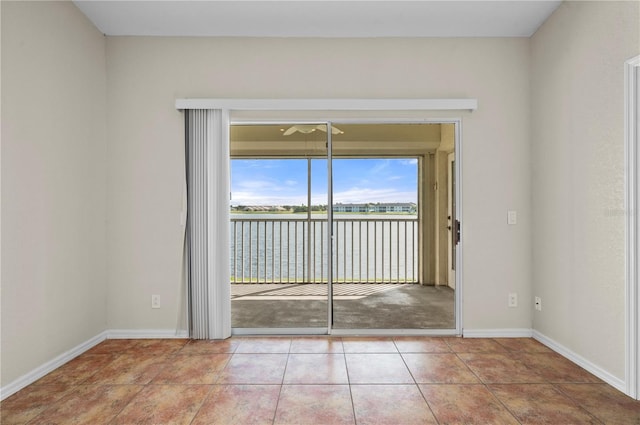 interior space with a water view and light tile patterned flooring