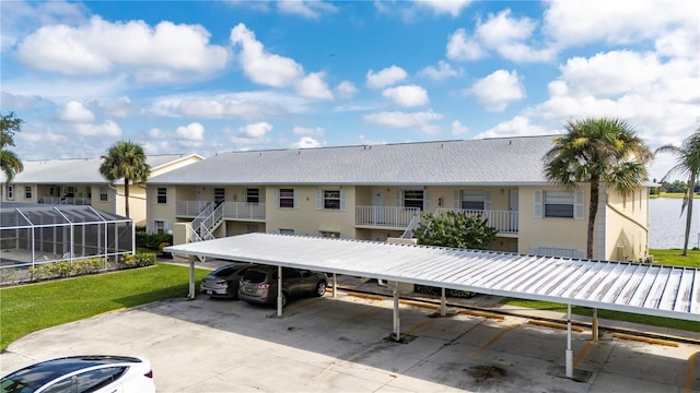 rear view of property with a water view and a yard