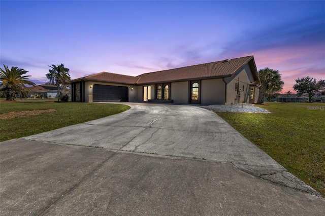 view of front of property featuring a yard and a garage