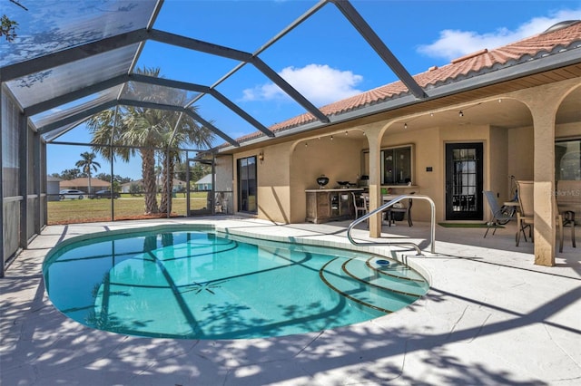 view of swimming pool with a patio area and glass enclosure