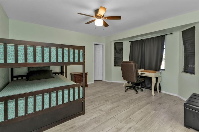 bedroom with ceiling fan and light hardwood / wood-style flooring