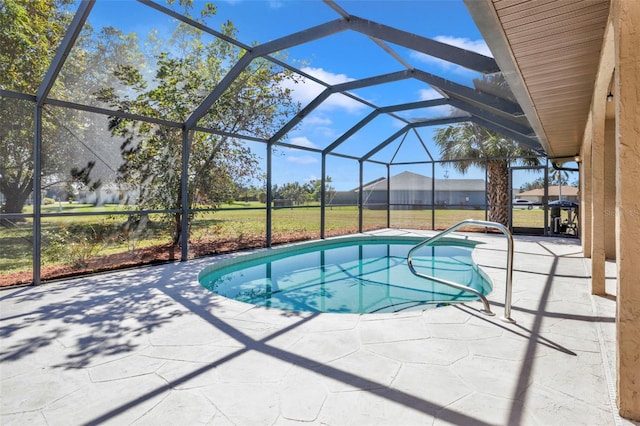 view of swimming pool featuring glass enclosure, a patio area, and a yard