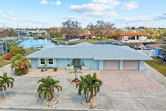 ranch-style home featuring a water view and a garage