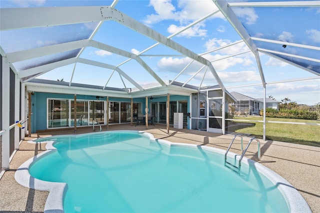 view of swimming pool with a patio, glass enclosure, and ceiling fan