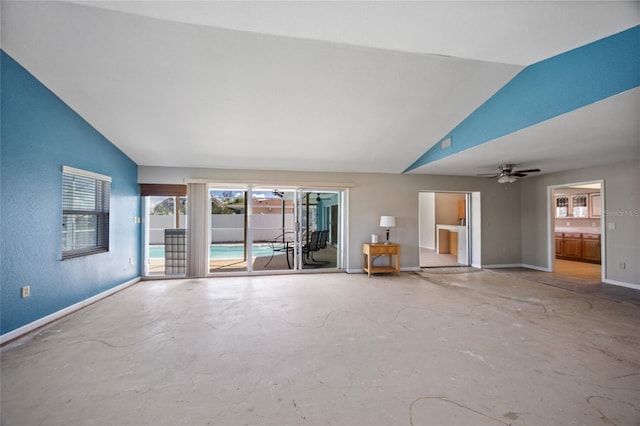 unfurnished living room with lofted ceiling, concrete floors, and ceiling fan