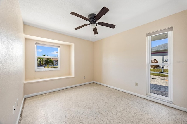 unfurnished room featuring ceiling fan and a textured ceiling