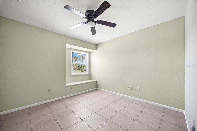 empty room featuring light tile patterned floors and ceiling fan