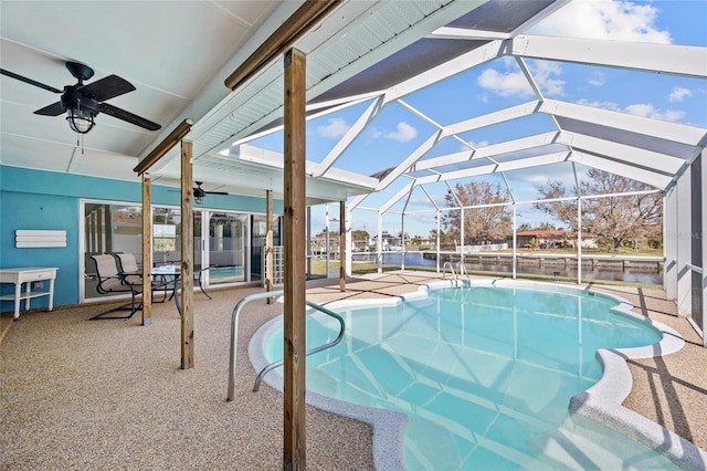 view of swimming pool featuring a patio, ceiling fan, and glass enclosure