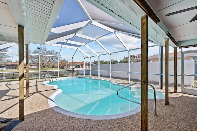 view of swimming pool with a patio area and glass enclosure