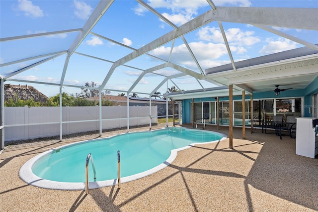 view of pool featuring a patio, ceiling fan, and glass enclosure