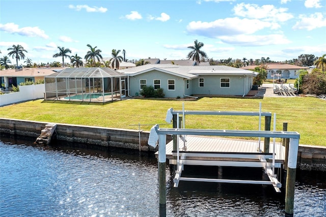 dock area with a lawn, a water view, and glass enclosure