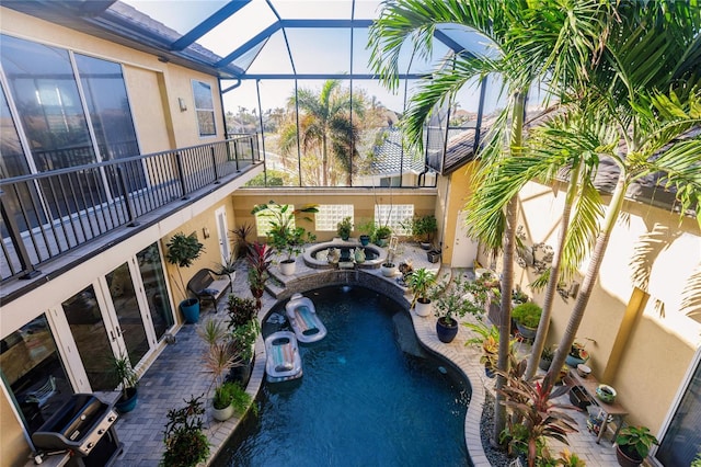 view of swimming pool with an in ground hot tub, a patio area, and glass enclosure