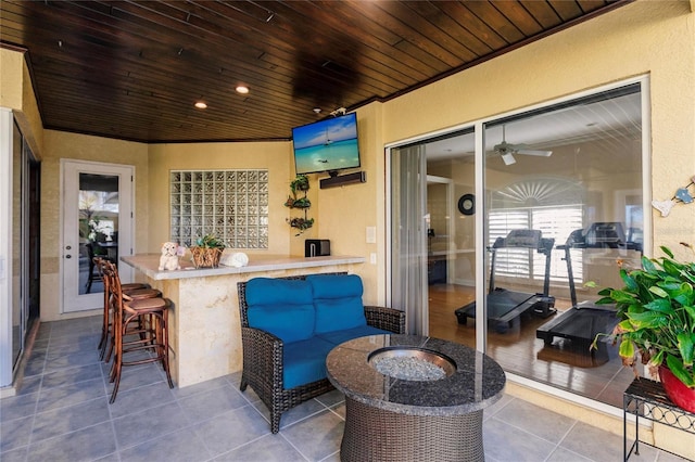 view of patio featuring an outdoor bar and ceiling fan