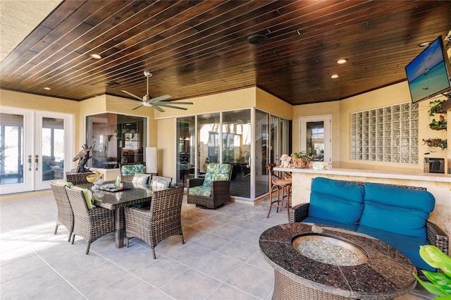 view of patio featuring french doors, an outdoor living space with a fire pit, and ceiling fan