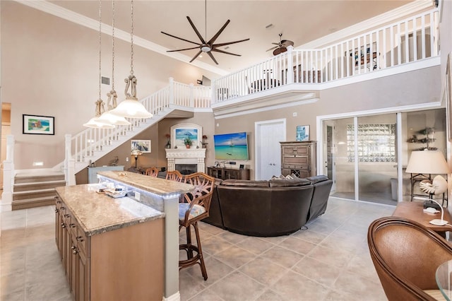 1209 San Mateo Dr, Punta Gorda, FL 33950 - living area with a towering ceiling, ceiling fan, a fireplace, light tile patterned floors, and stairway