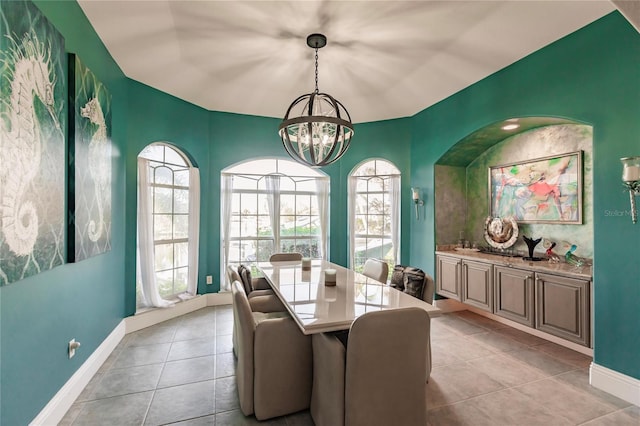 tiled dining area featuring a chandelier and plenty of natural light