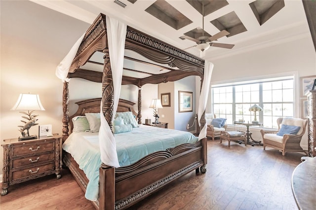 bedroom featuring hardwood / wood-style floors, ceiling fan, coffered ceiling, beam ceiling, and ornamental molding