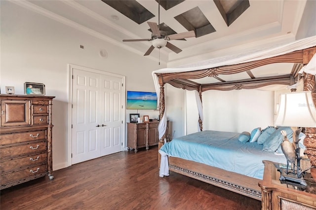 bedroom featuring beam ceiling, dark wood-type flooring, crown molding, and ceiling fan