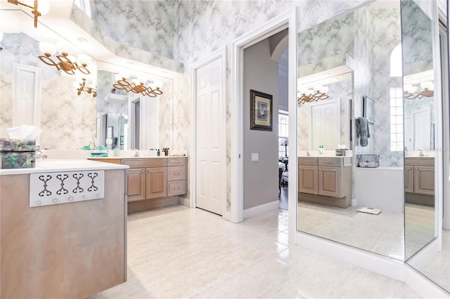 1209 San Mateo Dr, Punta Gorda, FL 33950 - bathroom featuring two vanities, wallpapered walls, and baseboards