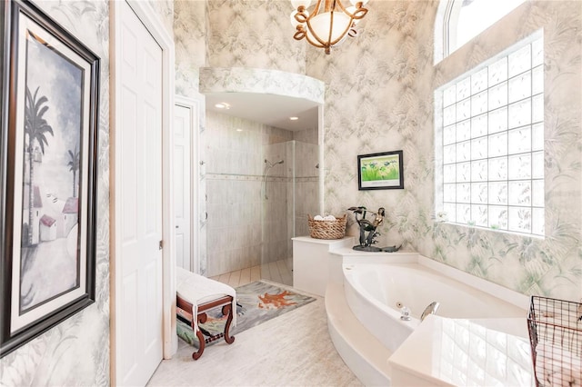 bathroom featuring shower with separate bathtub, plenty of natural light, and tile patterned flooring