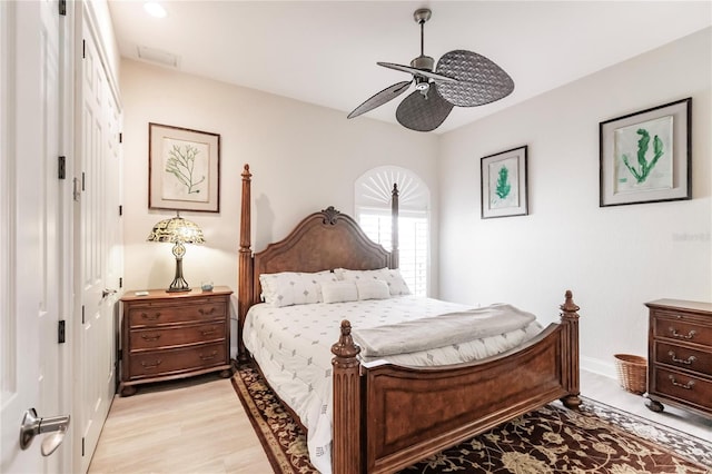 bedroom with light hardwood / wood-style flooring, a closet, and ceiling fan