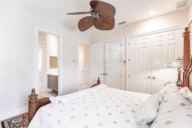 bedroom with multiple closets, ensuite bath, and ceiling fan