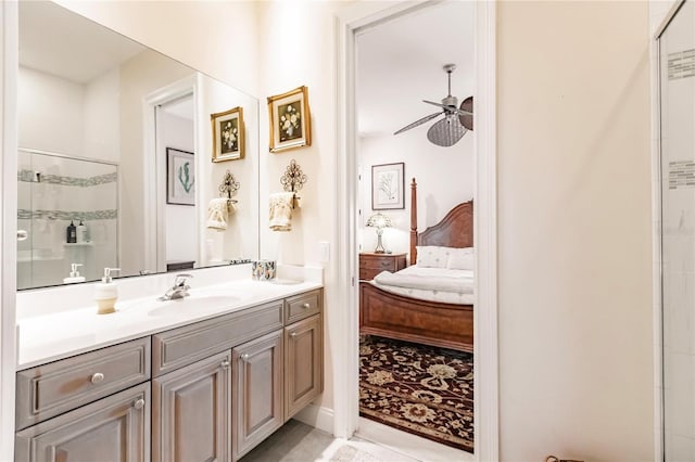 bathroom with a shower with door, vanity, and ceiling fan