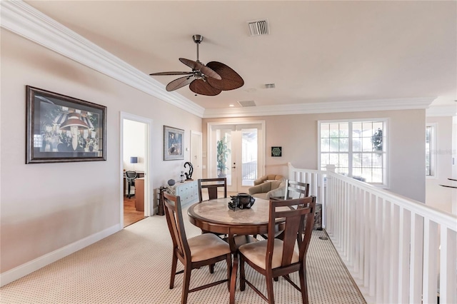 1209 San Mateo Dr, Punta Gorda, FL 33950 - dining room with ornamental molding, ceiling fan, light carpet, baseboards, and french doors