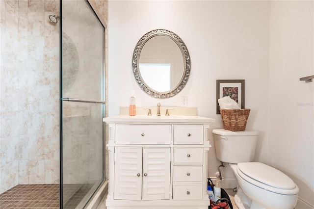 bathroom with toilet, walk in shower, and vanity