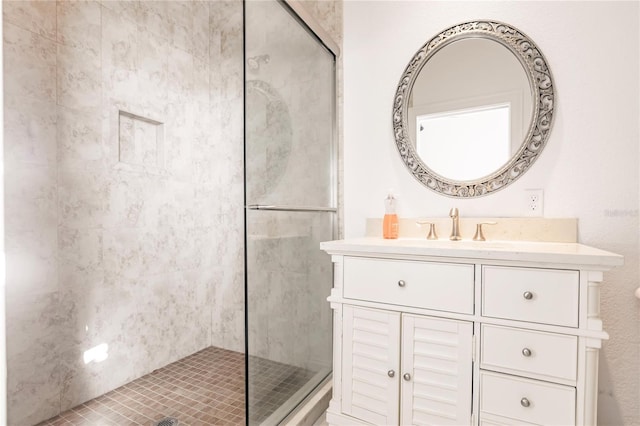 bathroom with vanity and a shower with shower door