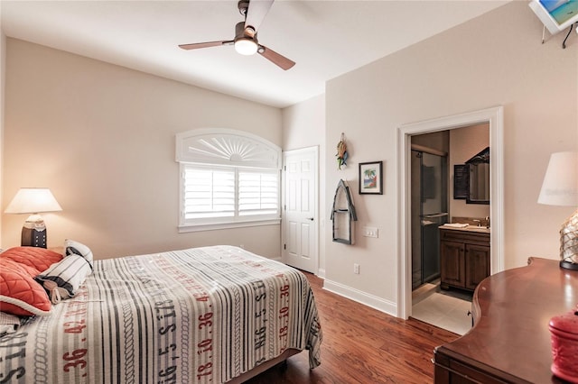 bedroom featuring ceiling fan, wood-type flooring, and ensuite bath