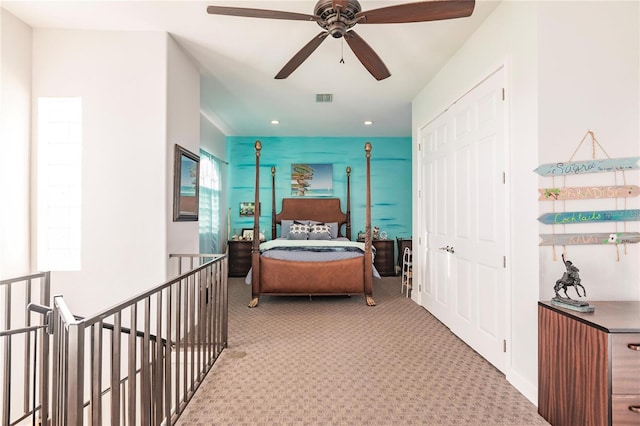 carpeted bedroom featuring multiple windows and a closet