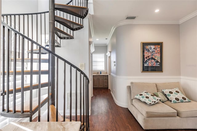 stairs with crown molding and hardwood / wood-style floors