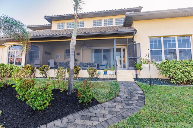 1209 San Mateo Dr, Punta Gorda, FL 33950 - back of house featuring stucco siding, a ceiling fan, a tile roof, and a sunroom