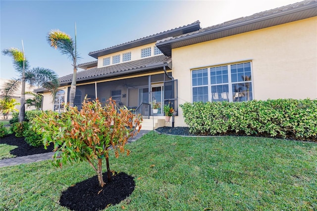 exterior space with a front yard and a sunroom