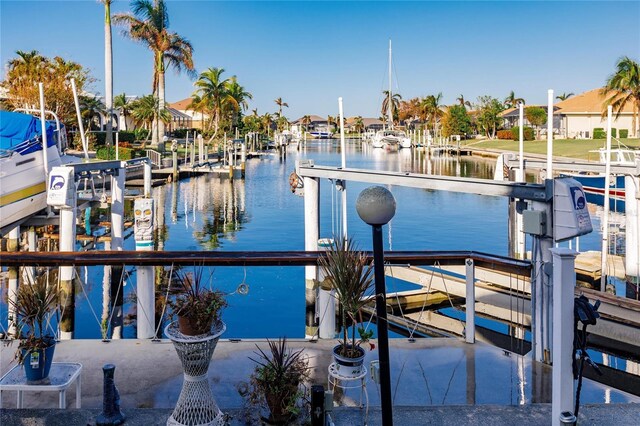 1209 San Mateo Dr, Punta Gorda, FL 33950 - dock featuring boat lift, a water view, and a residential view