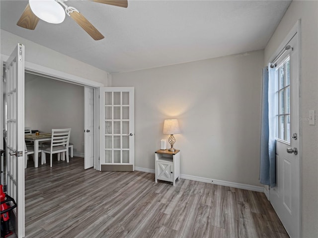 interior space with french doors, hardwood / wood-style floors, and ceiling fan