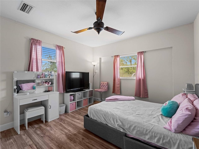 bedroom with ceiling fan and hardwood / wood-style flooring