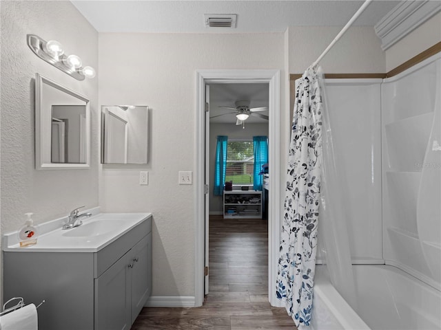 bathroom featuring ceiling fan, shower / tub combo, hardwood / wood-style floors, and vanity