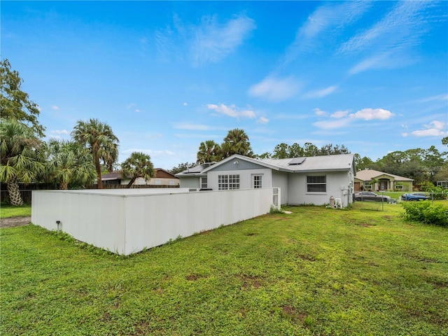 back of property featuring a lawn