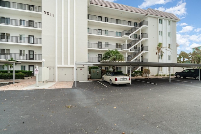 9011 Midnight Pass Rd Unit 329, Sarasota, FL 34242 - view of apartment building / complex featuring covered parking