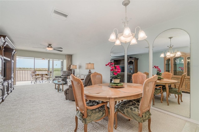 9011 Midnight Pass Rd Unit 329, Sarasota, FL 34242 - dining area featuring a chandelier, light colored carpet, and a ceiling fan
