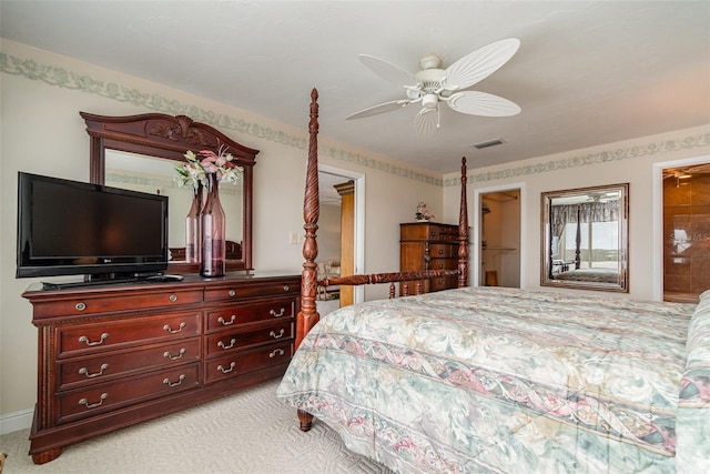 carpeted bedroom featuring a closet, ceiling fan, and a walk in closet